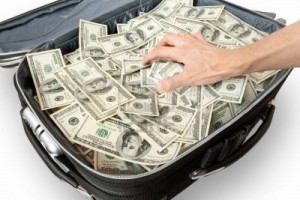 6143374-greed--lot-of-money-in-a-suitcase-with-hand